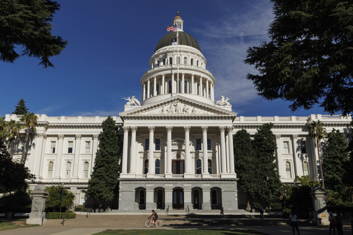 FILE - People walk around the California State Capitol, Aug. 5, 2024, in Sacramento, Calif. (AP Pho...