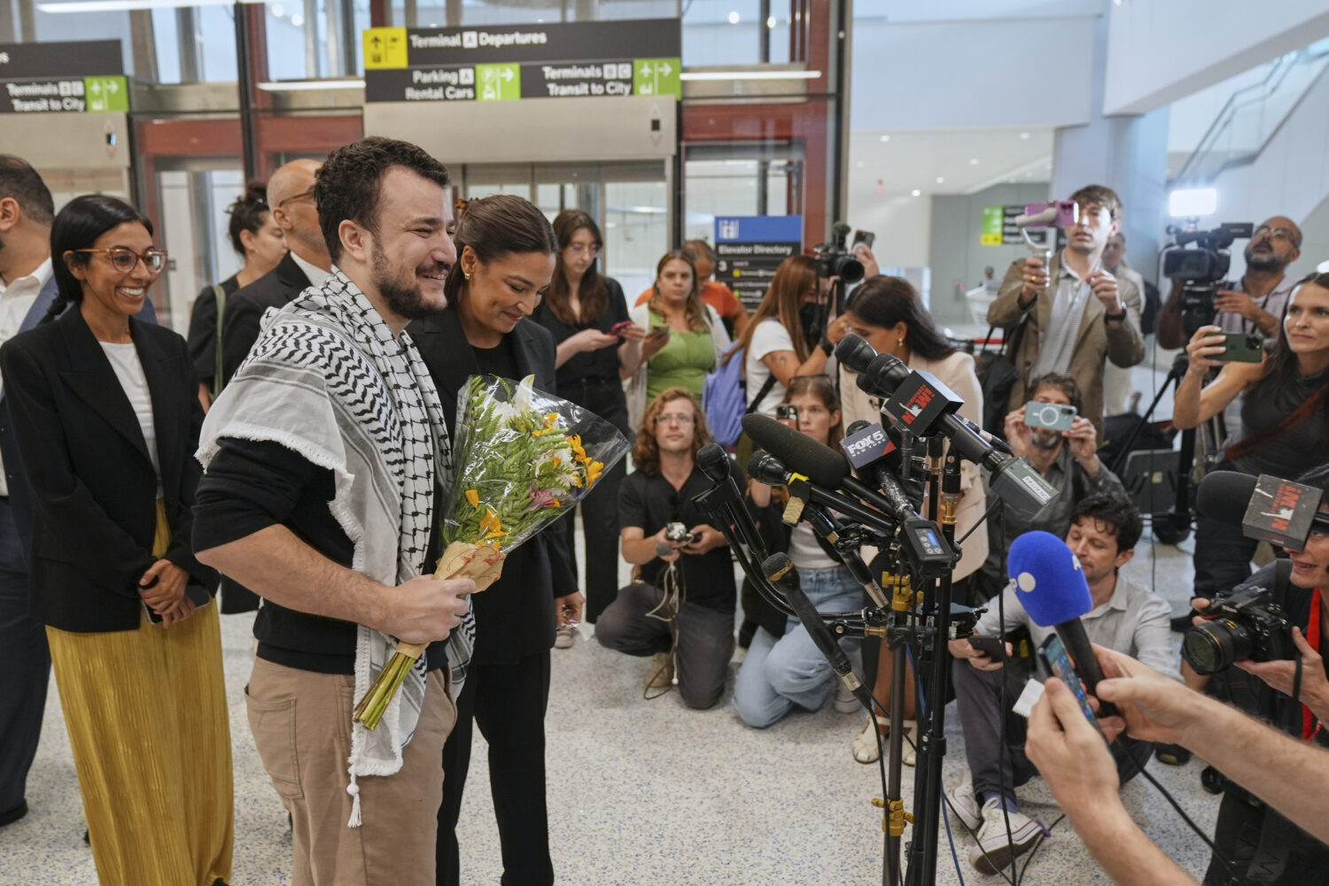 Mahmoud Khalil, second from left, alongside Rep. Alexandria Ocasio-Cortez, prepares to speak at a n...