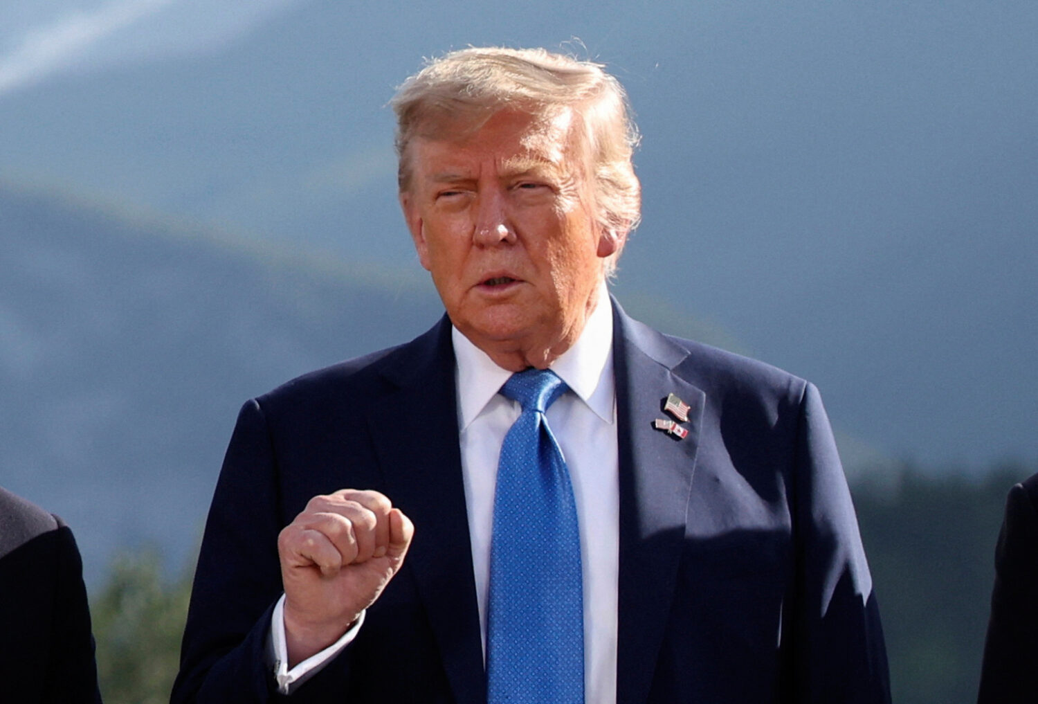 U.S. President Donald Trump gestures as he attends a family photo session during the G7 Summit, in ...