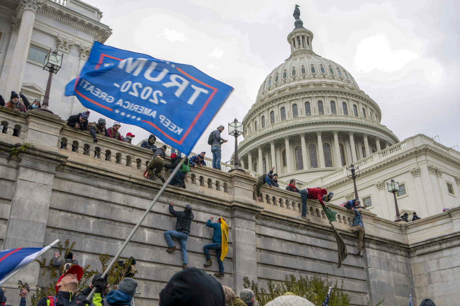 FILE - Support of President Donald Trump climb the West Wall of the the U.S. Capitol on Jan. 6, 202...
