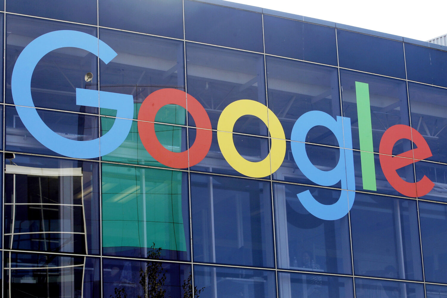 FILE - A sign is displayed on a Google building at their campus in Mountain View, Calif., Sept. 24,...