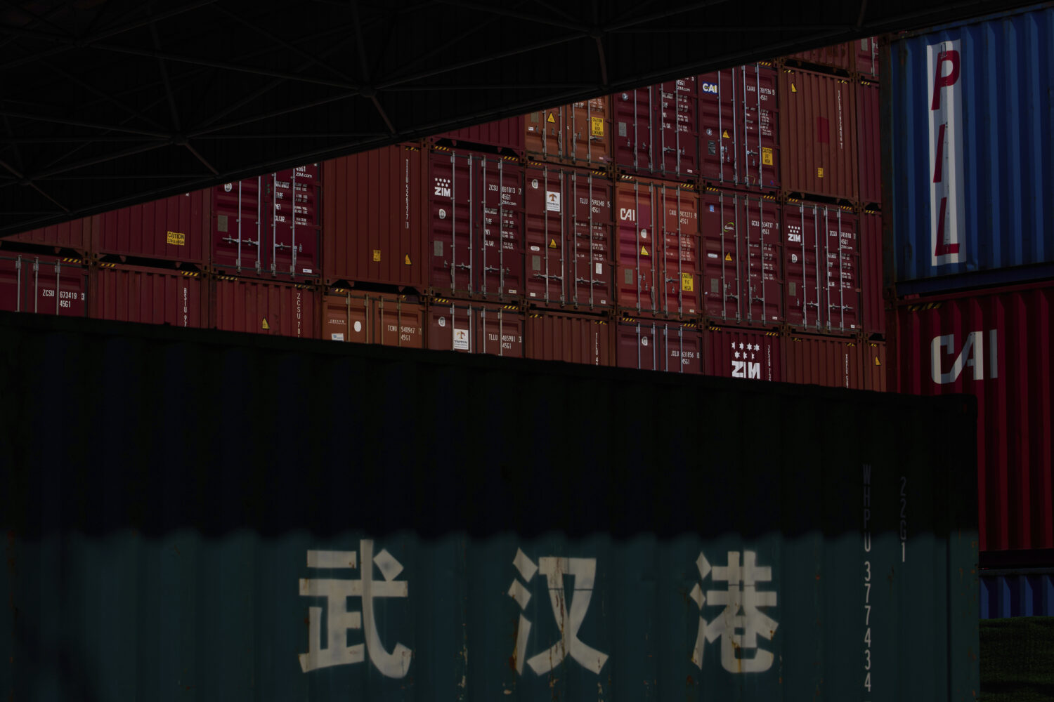 Stacked containers are seen at the Yangluo Port on the Yangtze River in Wuhan, central China's Hube...