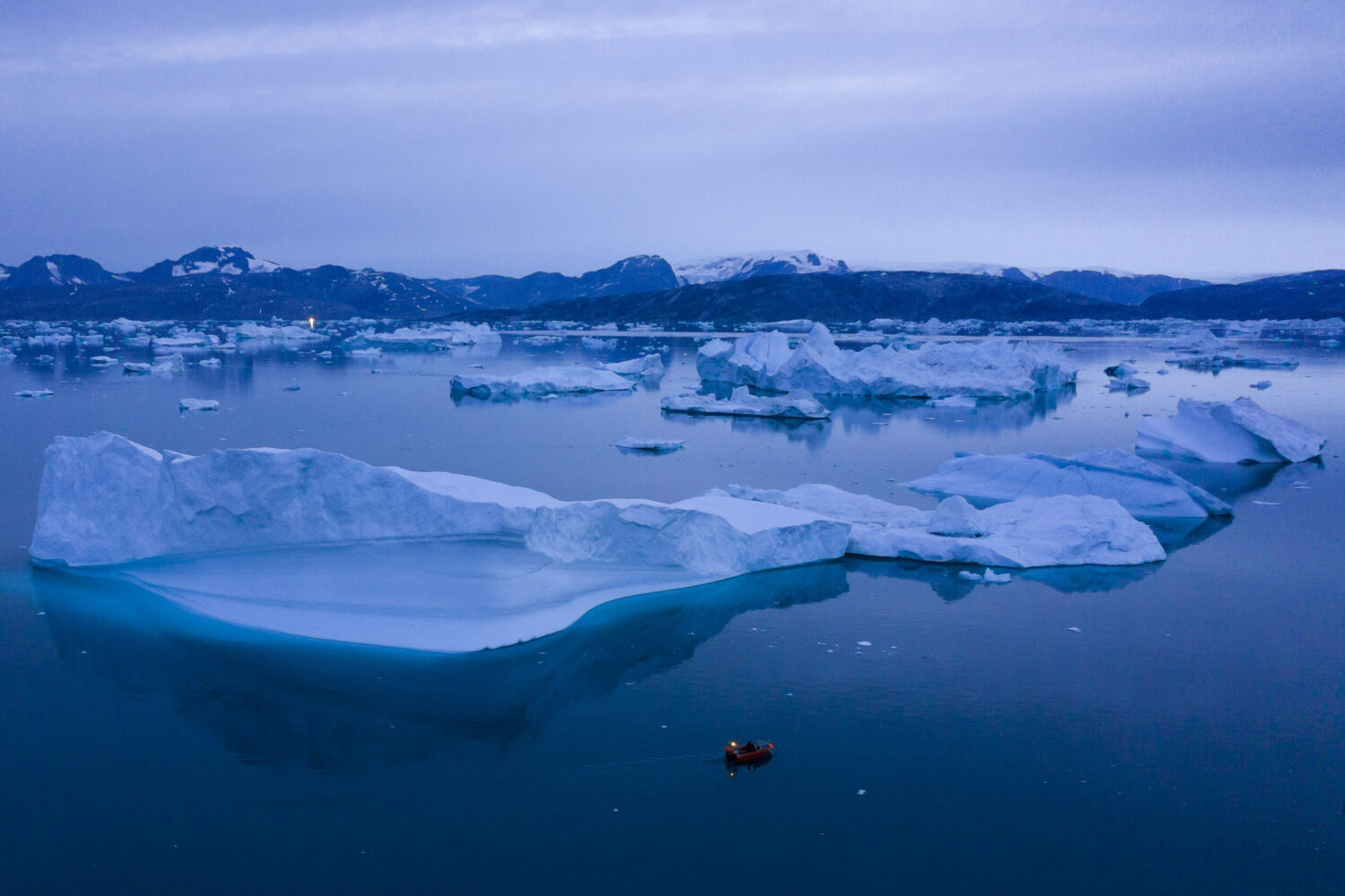 FILE - A boat navigates large icebergs near Kulusuk, in eastern Greenland, on Aug. 15, 2019. (AP Ph...