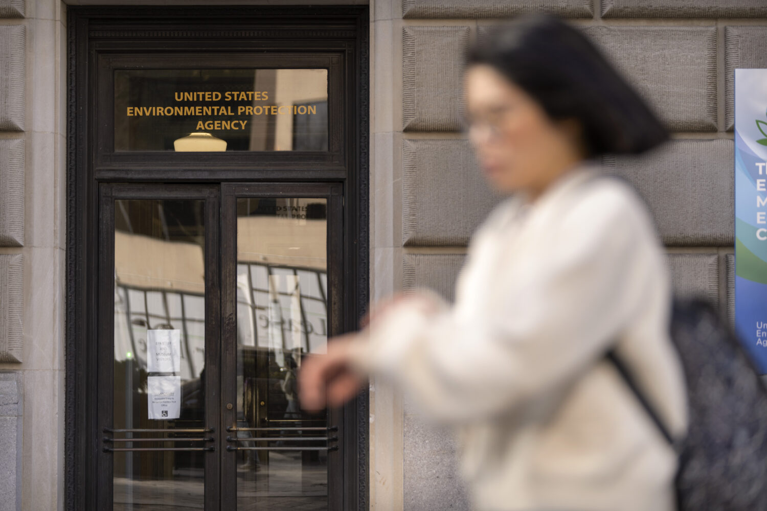 FILE - A person walks past the headquarters building of the Environmental Protection Agency, March ...