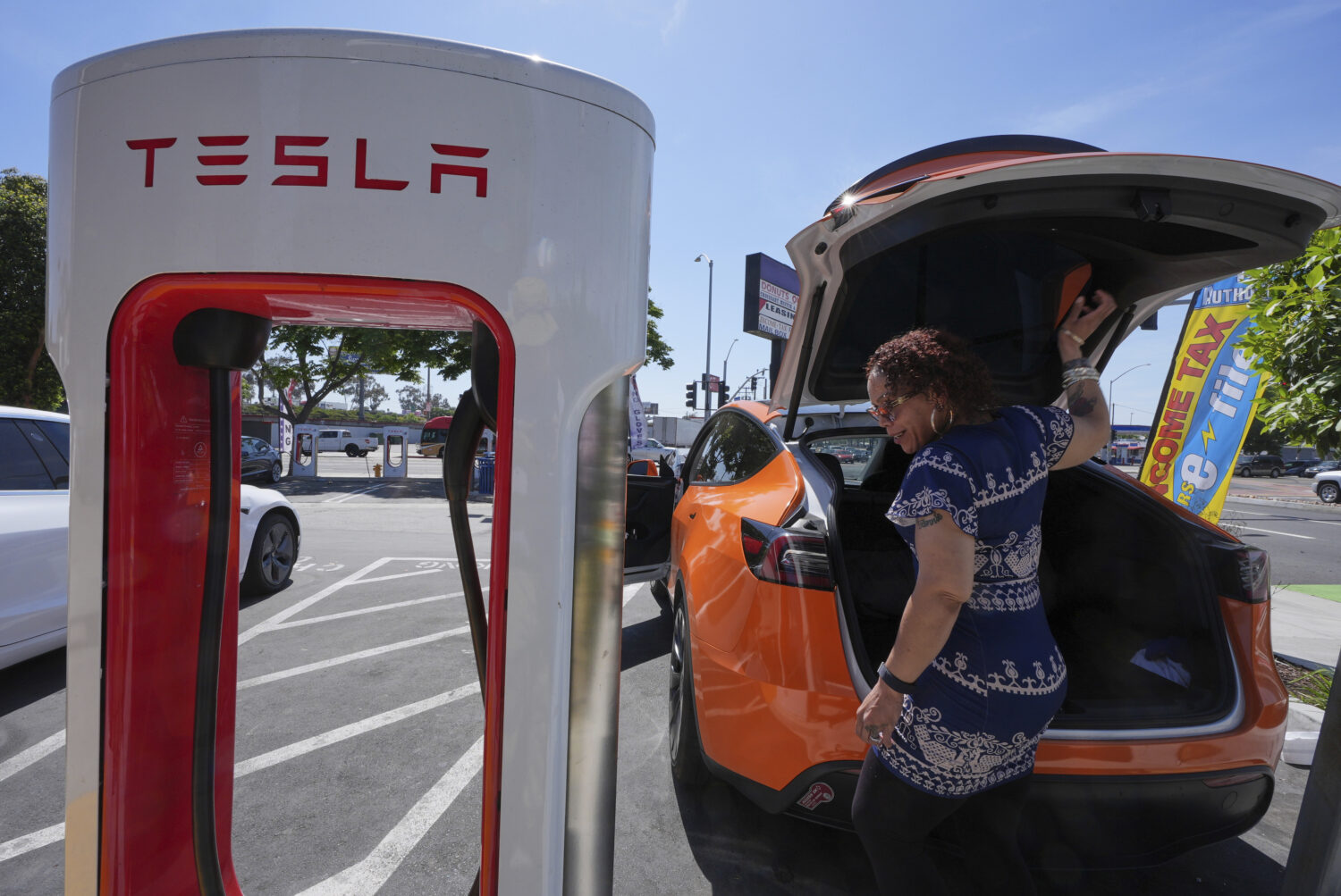 Janelle Lowe prepares to charge her electric vehicle at a charging station Thursday, May 22, 2025, ...