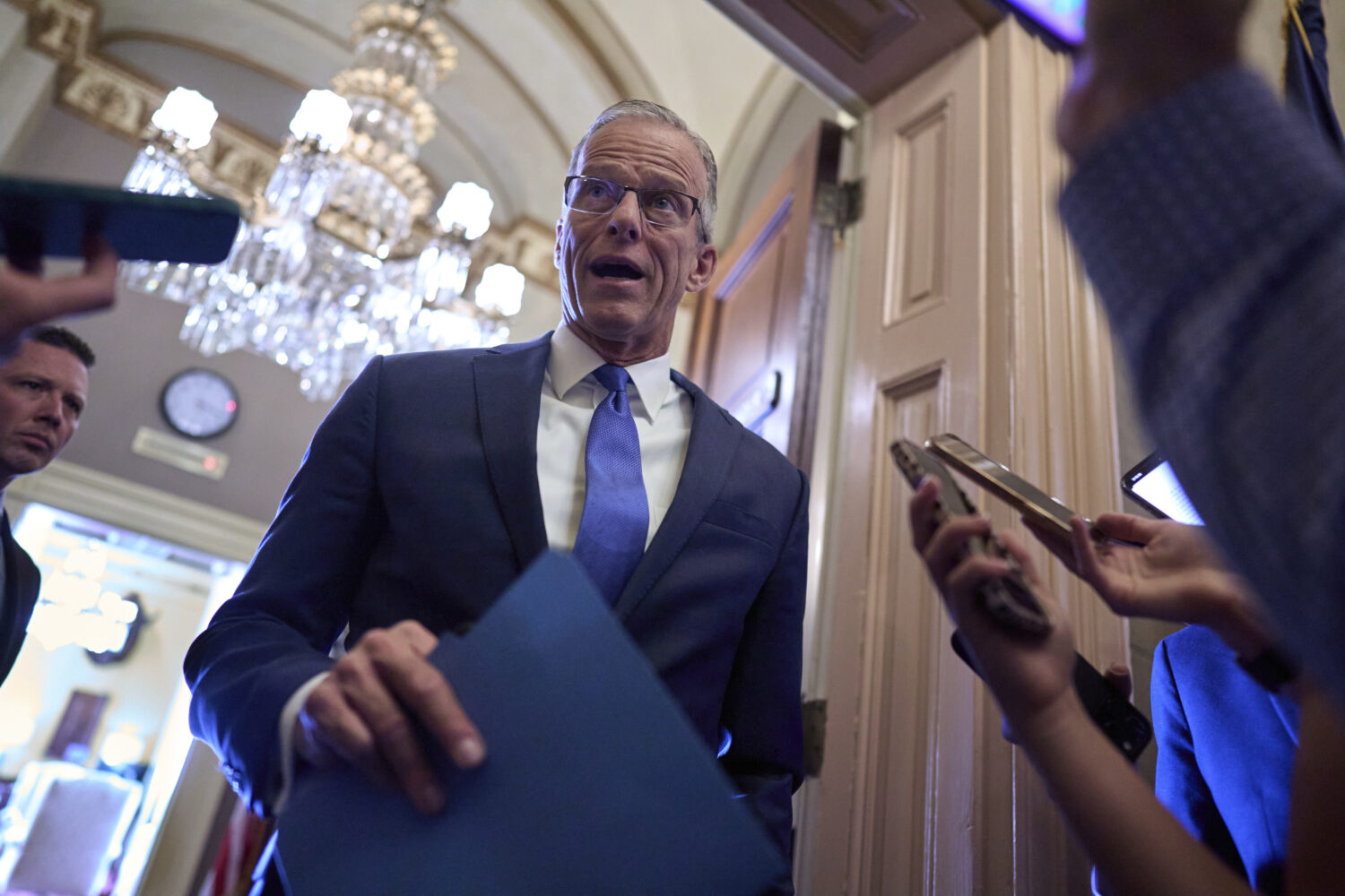 Senate Majority Leader John Thune, R-S.D., pauses in the door of his office to answer questions fro...