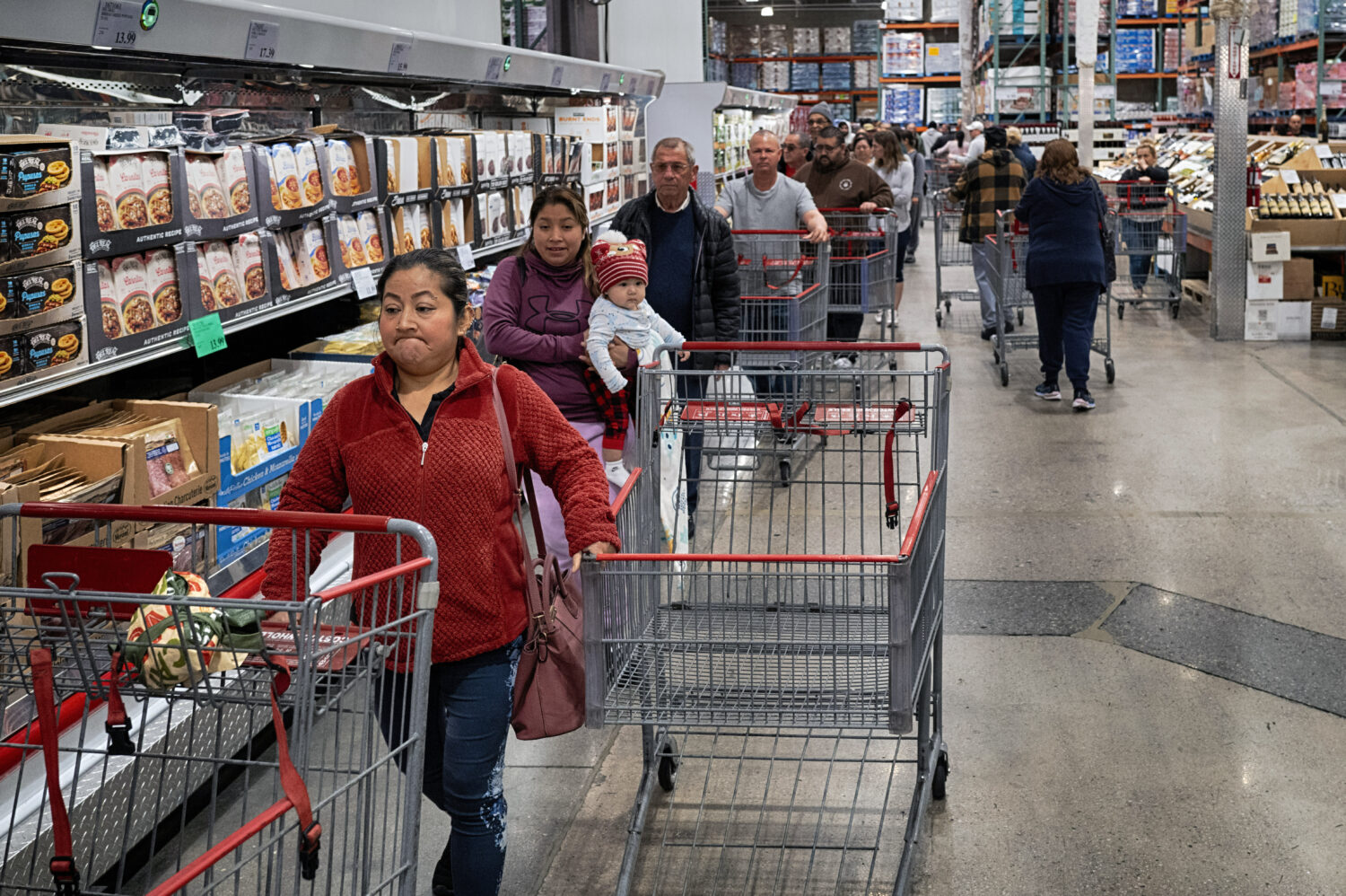FILE - Customers wait in line for eggs at a Costco store in the Van Nuys section of Los Angeles on ...