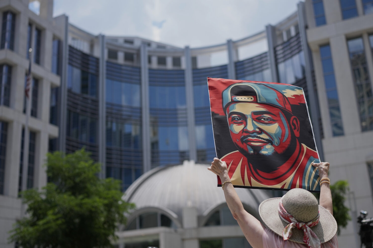 Katheryn Millwee holds a portrait of Kilmar Abrego Garcia outside the federal courthouse Wednesday,...
