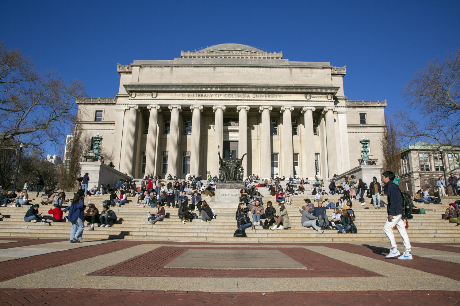 FILE - Students sit on the front steps of Low Memorial Library on the Columbia University campus in...