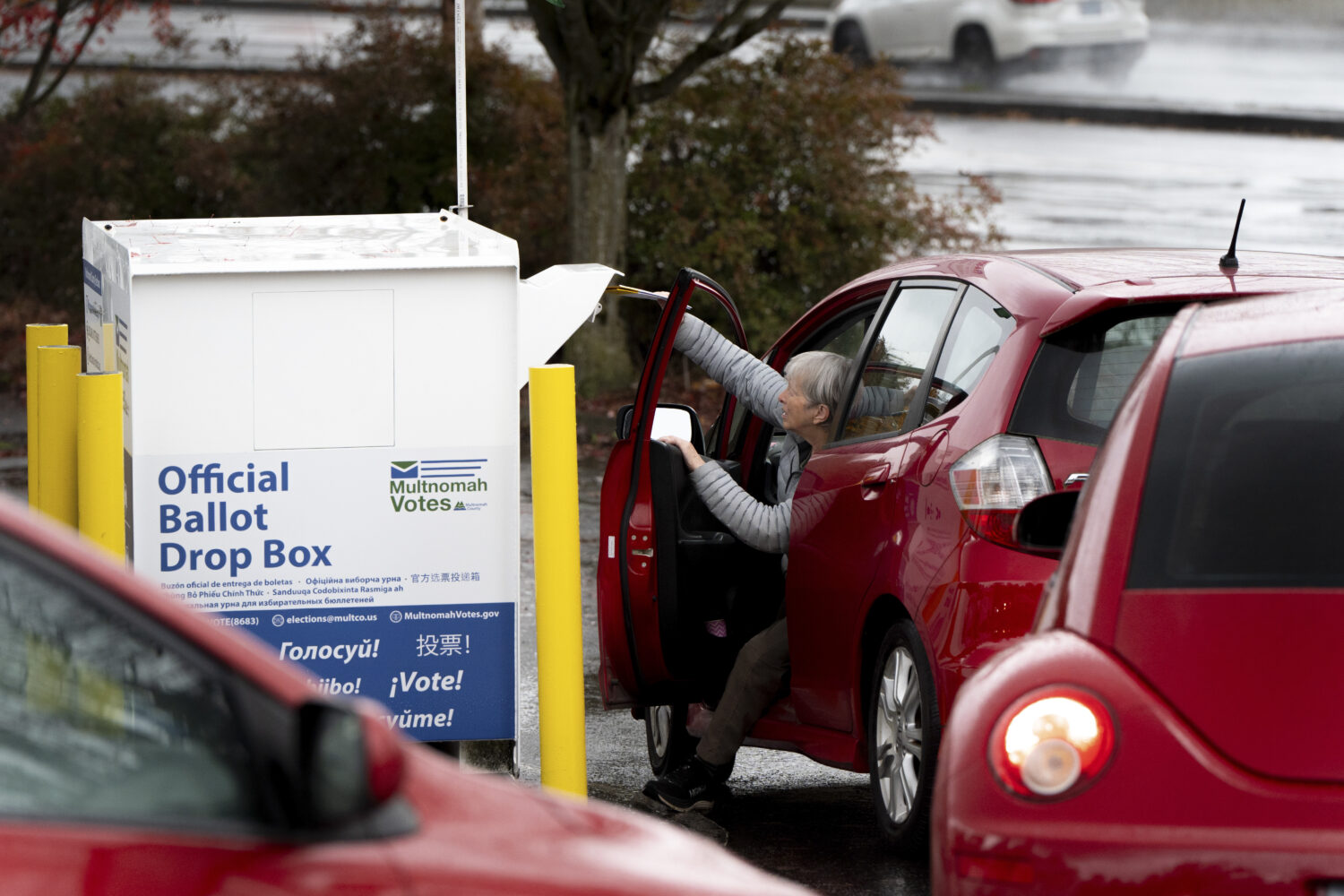 FILE - A voter drops off their ballot at a dropbox on Election Day, Tuesday, Nov. 5, 2024, in Portl...