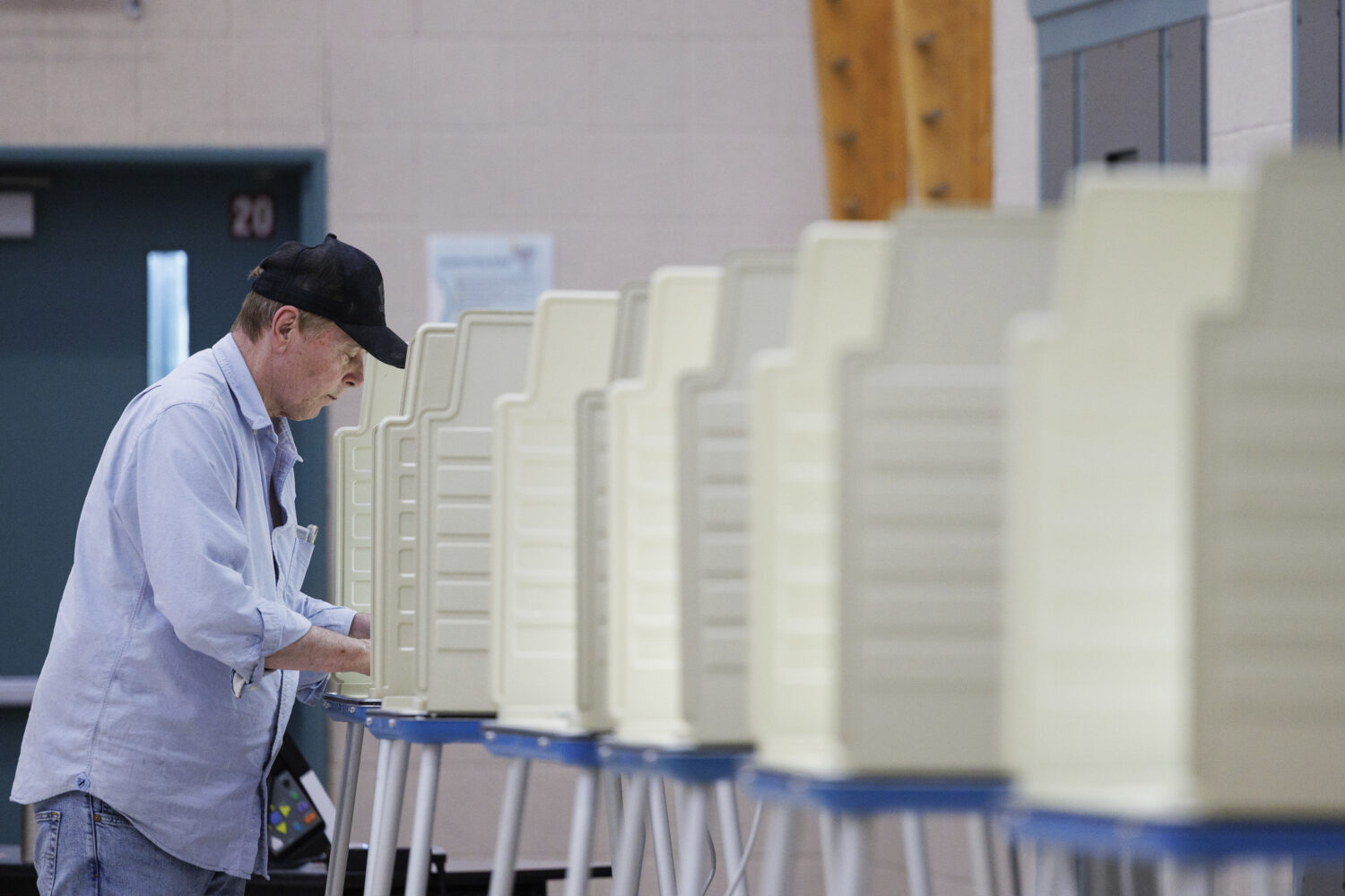 Kim Wilcox casts his ballot in the Omaha municipal election at Black Elk Elementary School, Tuesday...