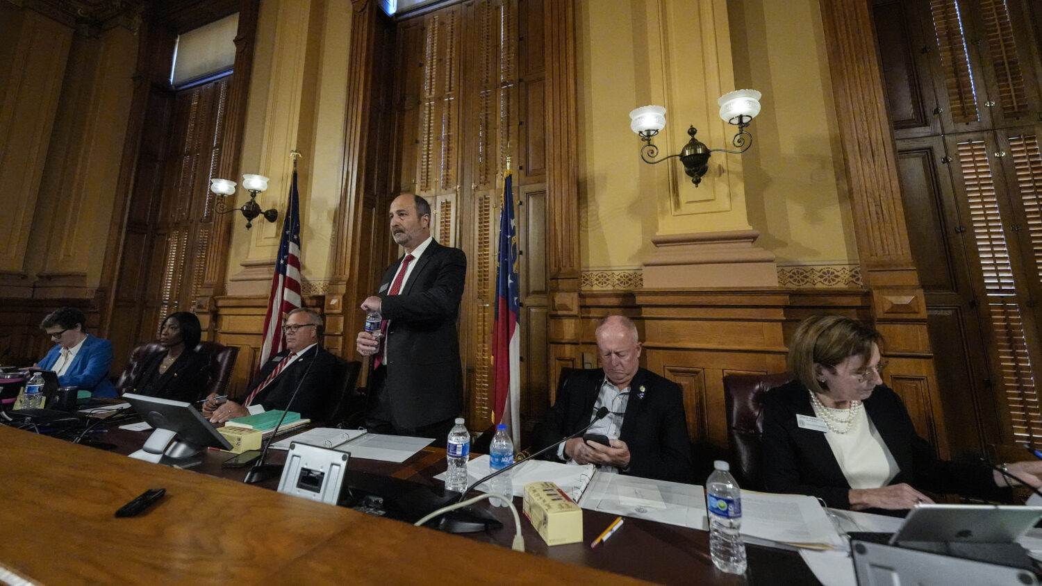 FILE - Georgia's State Election Board members discuss proposals for election rule changes at the st...