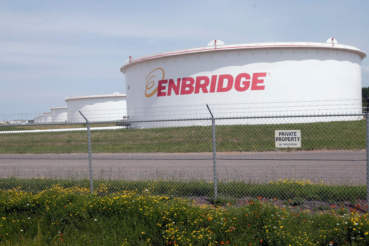 FILE - The corporate name stands out on tanks shown June 29, 2018 at at the Superior terminal of En...