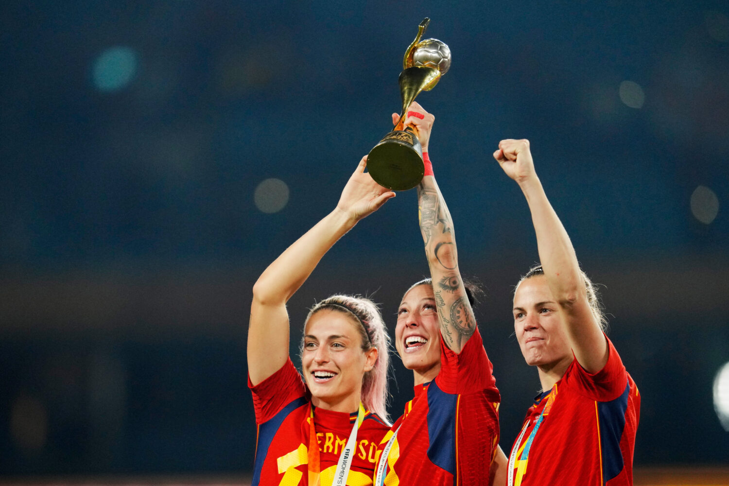 FILE - Spain's Alexia Putellas, Jennifer Hermoso and Irene Paredes, from left, celebrate with the t...