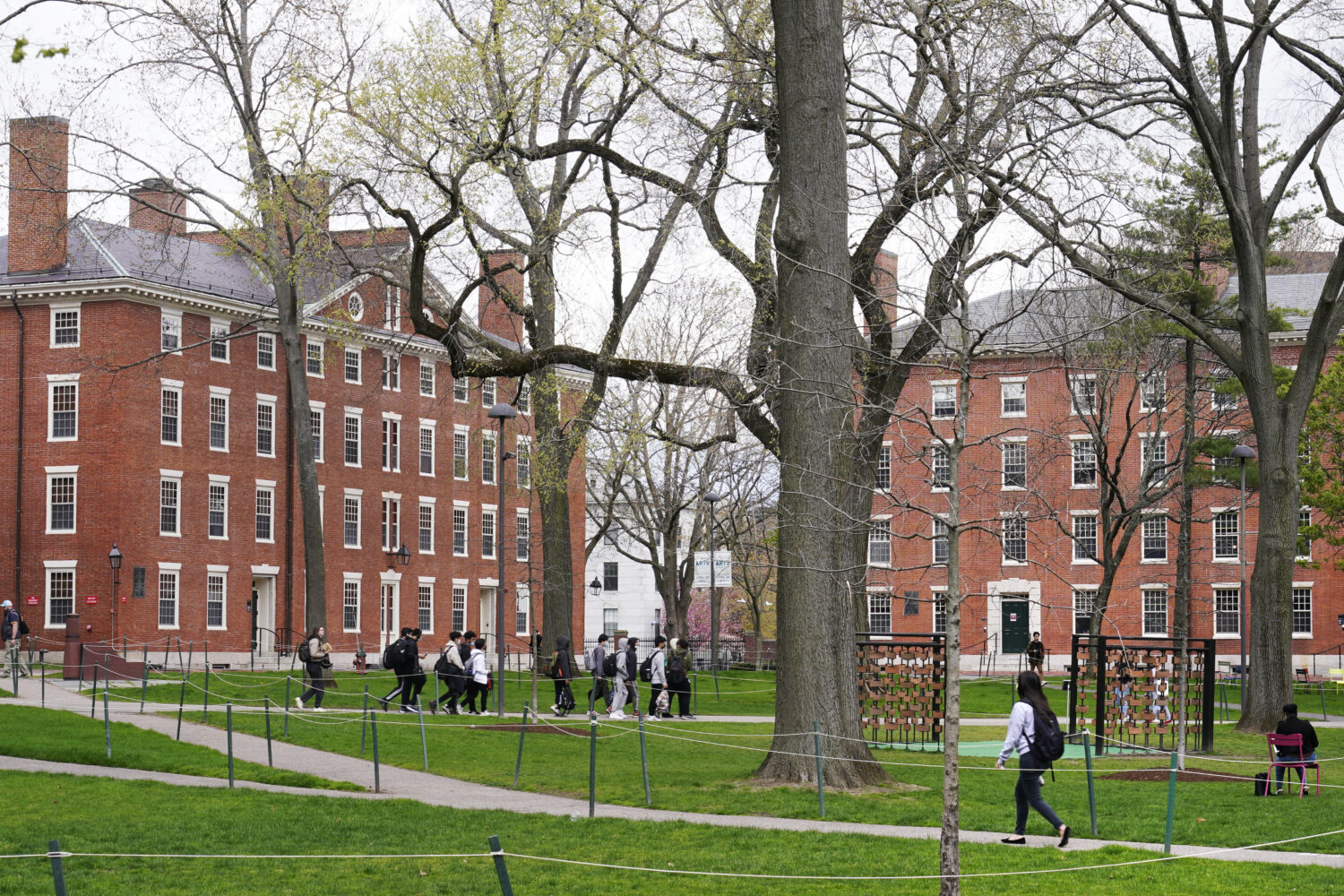 FILE - Students walk through Harvard Yard, April 27, 2022, on the campus of Harvard University in C...