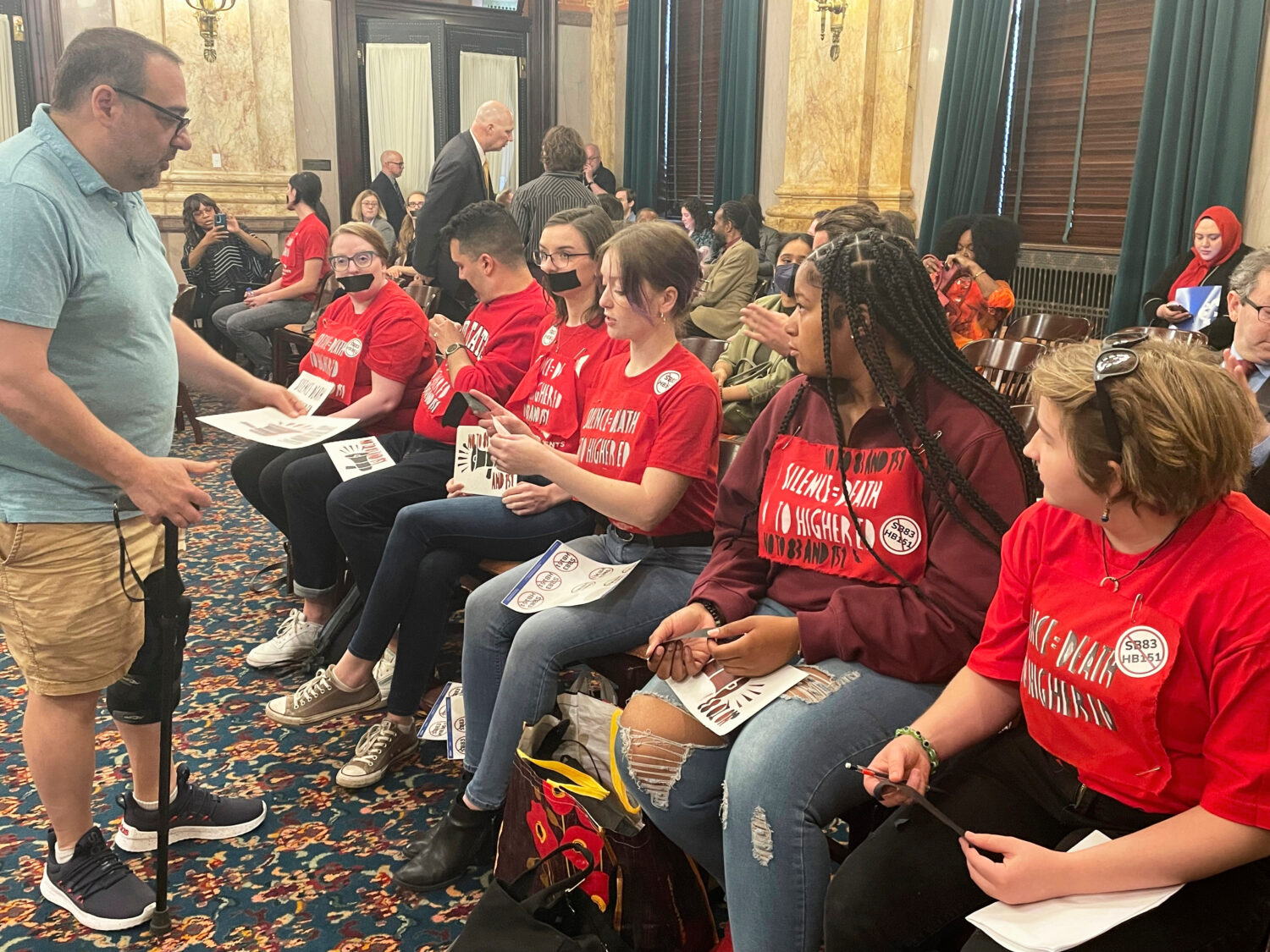 FILE - Opponents of a multifaceted higher education bill protest across the Ohio Statehouse in Colu...