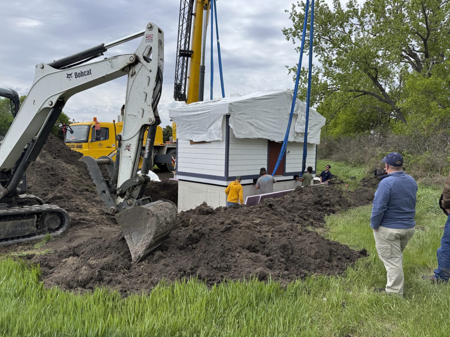 Workers install a restroom at the Welk Homestead State Historic Site near Strasburg, North Dakota, ...
