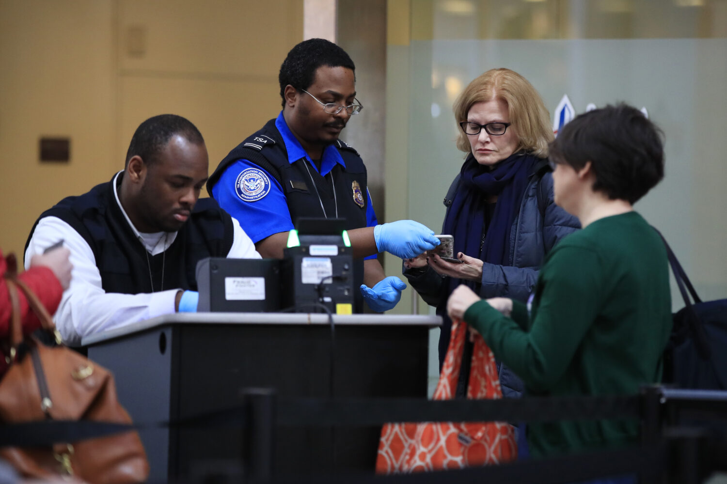 FILE - Transportation Security Administration workers screen airline passengers at Reagan Washingto...