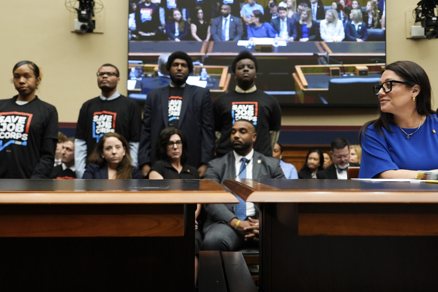 Secretary of Labor Lori Chavez-DeRemer looks as Job Corps members stand behind her during a House E...