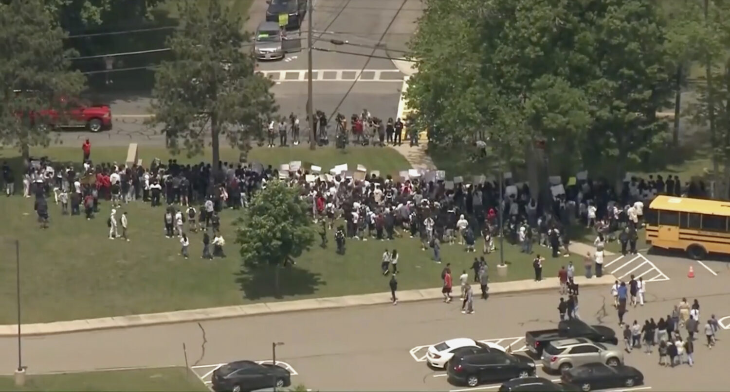 Students take part in a walkout in support of an 18-year-old volleyball player detained by federal ...