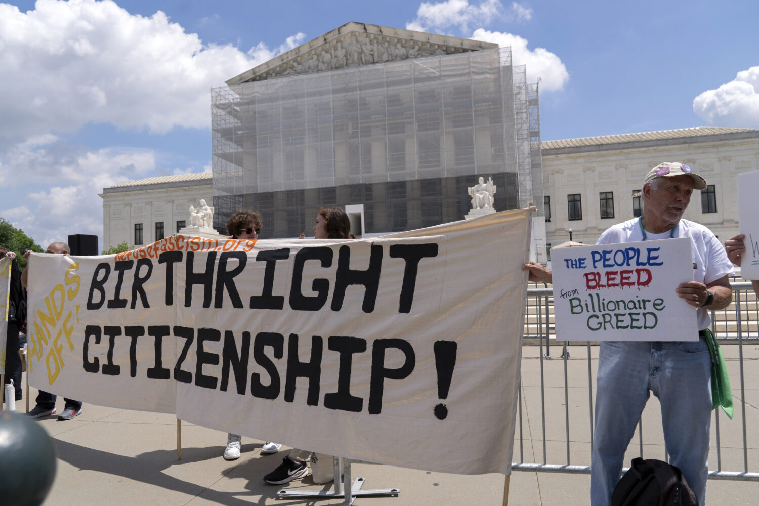 FILE - Demonstrators holds up a banner during a citizenship rally outside of the Supreme Court in W...