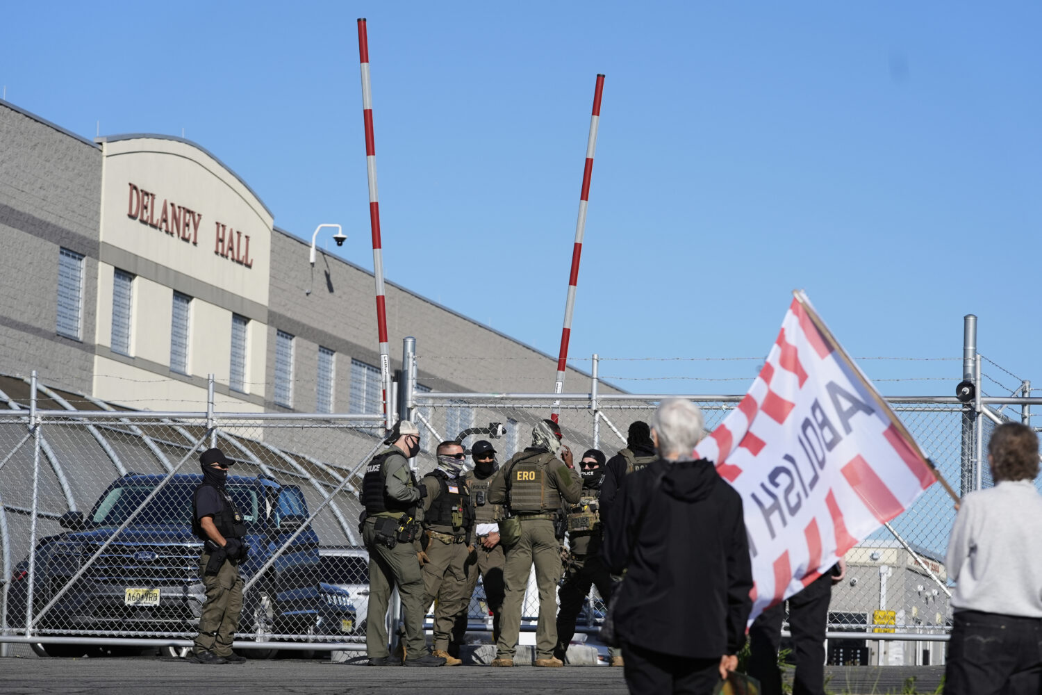 Protesters and security stand in front of Delaney Hall, a recently re-opened immigration detention ...