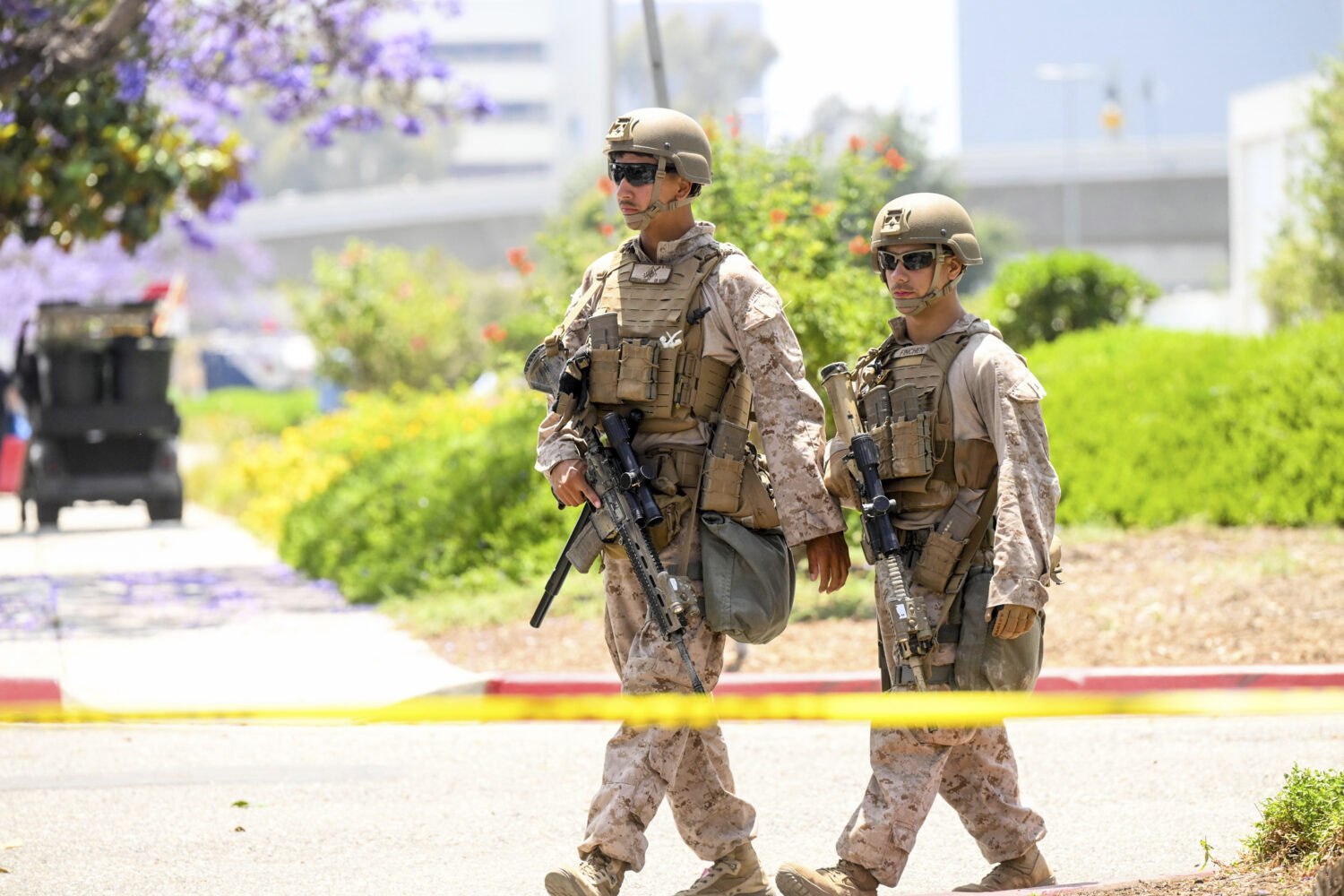 U.S Marines work outside of a federal building, Friday, June 13, 2025, in Los Angeles (AP Photo/Noa...