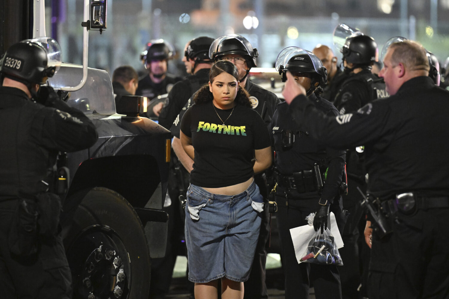 Law enforcement handcuff a woman during a protest on Thursday, June 12, 2025, in Los Angeles. (AP P...