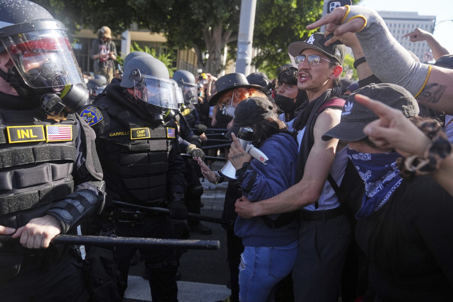 Protesters confront police on the 101 Freeway near the metropolitan detention center of downtown Lo...