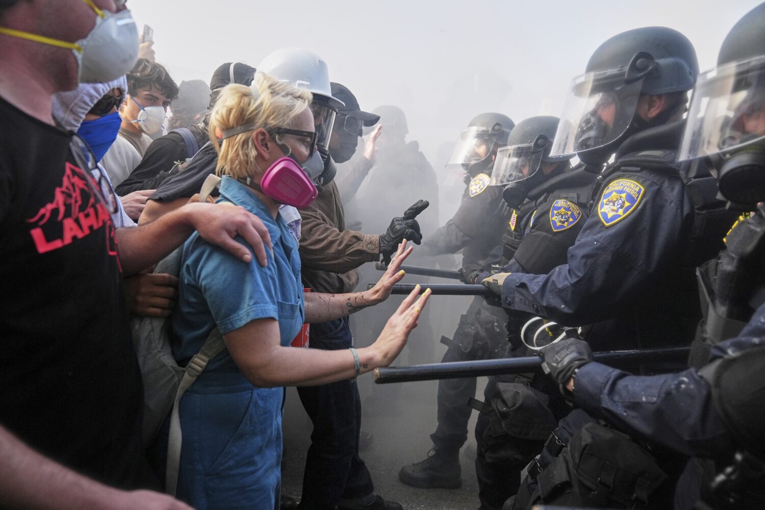 FILE - Protesters confront police on the 101 Freeway near the Metropolitan Detention Center in down...