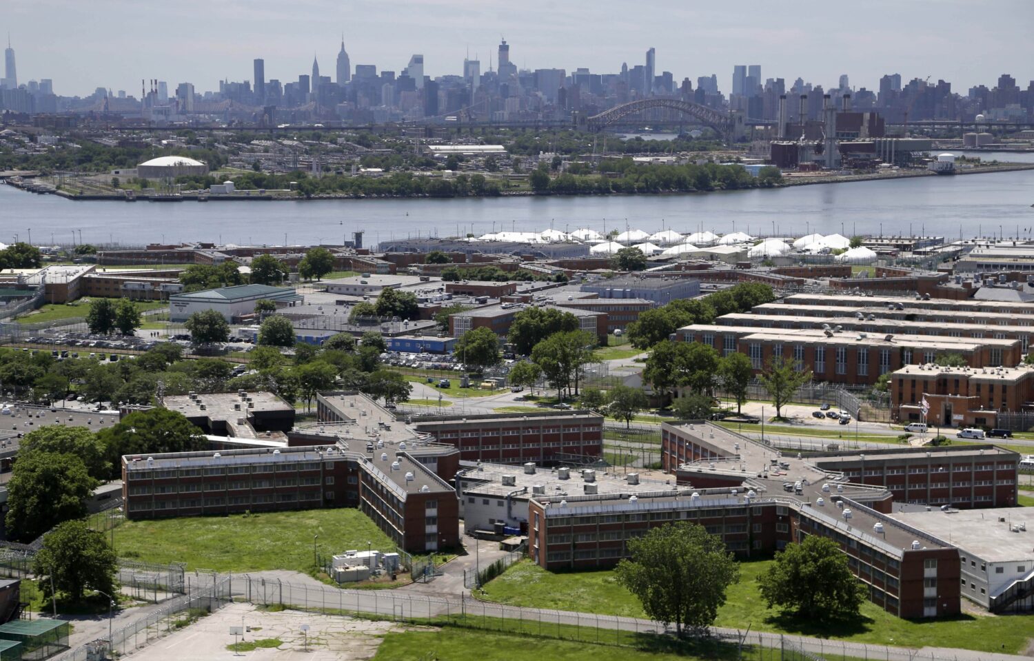 FILE - The Rikers Island jail complex stands in New York with the Manhattan skyline in the backgrou...