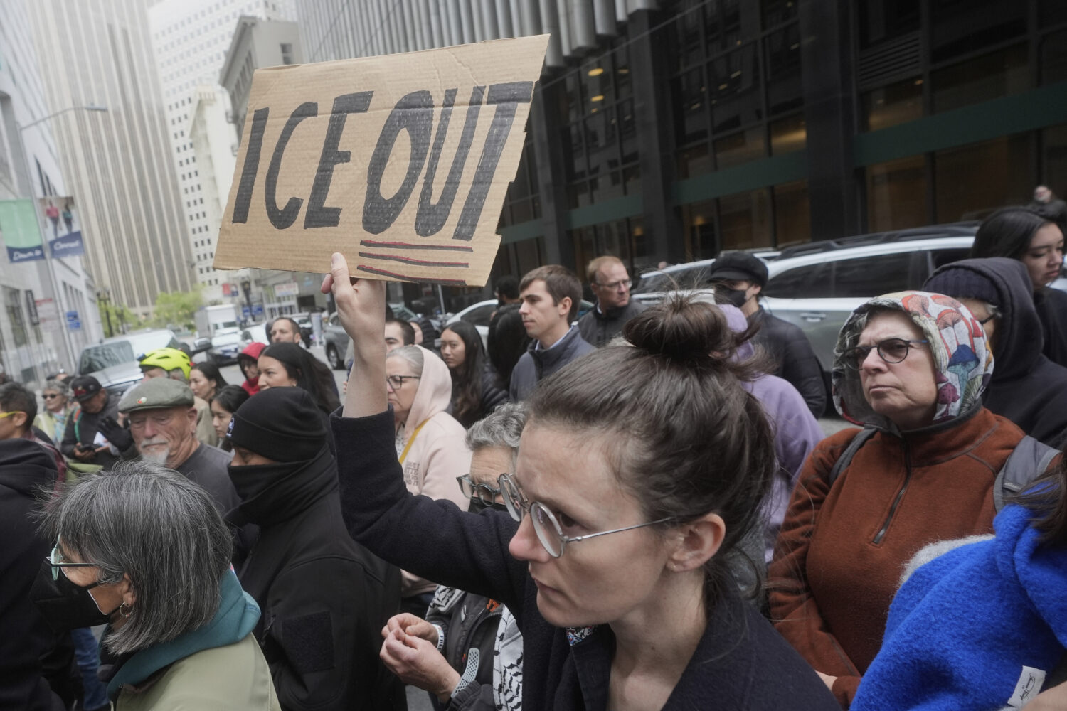 FILE - A person holds up a sign during a news conference and rally by immigrant justice organizatio...