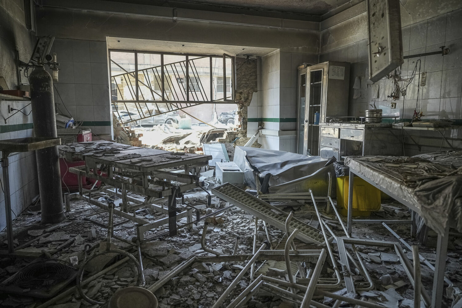 In this photo taken Tuesday, June 24, 2025, rescuers search through the rubble of a damaged section...