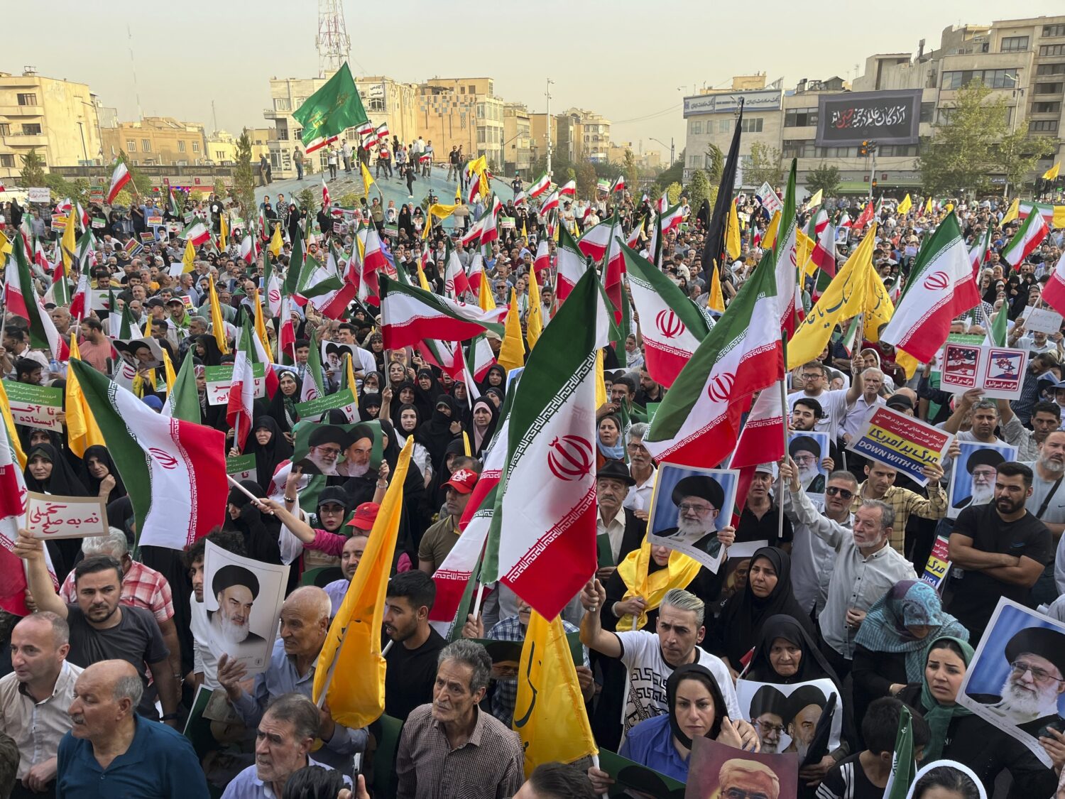 Protestors carry Iranian national flags and posters of the late revolutionary founder Ayatollah Kho...