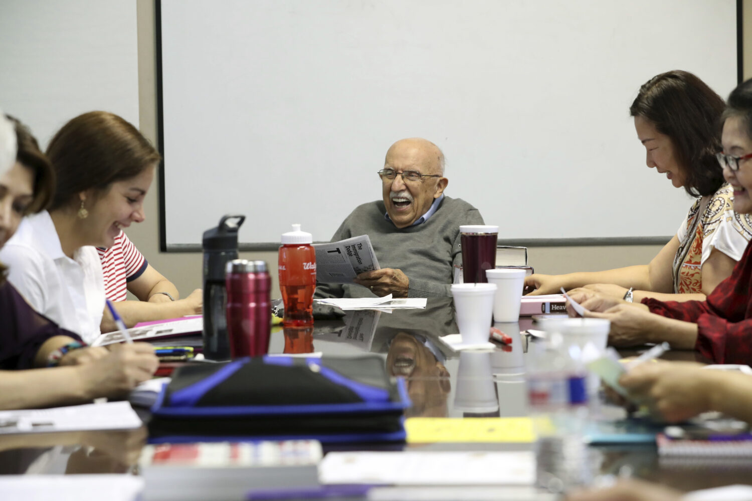 FILE - Instructor Vito Susca shares a laugh with his English as a Second Language class at the Fort...