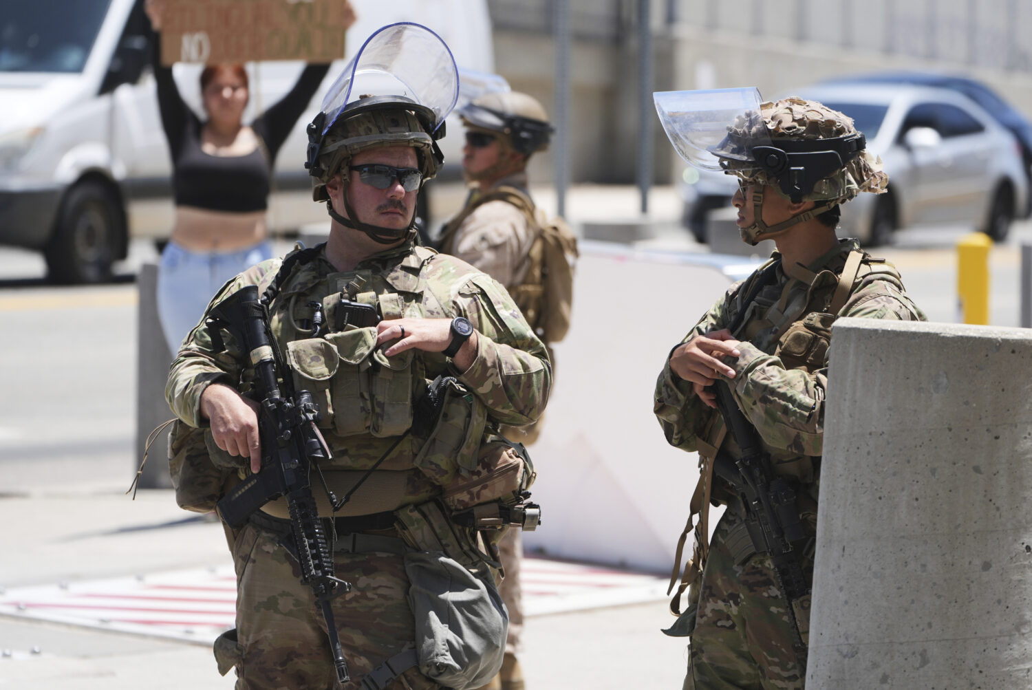 Members of the California National Guard and U.S. Marines guard a federal building on Tuesday, June...