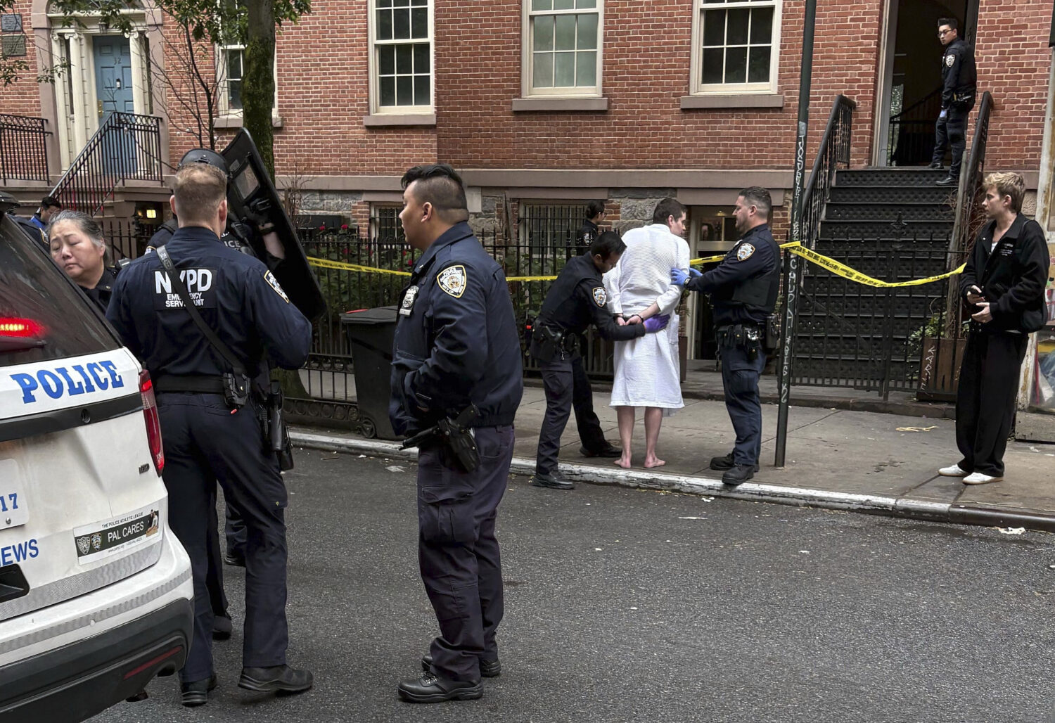 New York police officers arrest John Woeltz, Friday, May 23, 2025, in New York, who was charged wit...