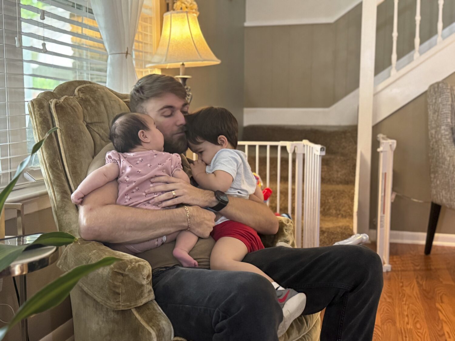 U.S. Marine Corps veteran Adrian Clouatre holds his 3-month-old daughter Lyn and his nearly two old...