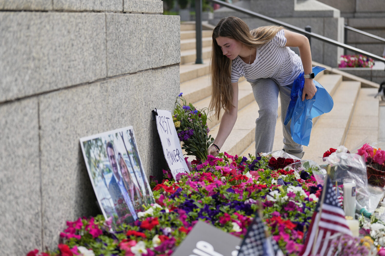 Claire Stein places flowers at a makeshift memorial for Minnesota state Rep. Melissa Hortman and he...