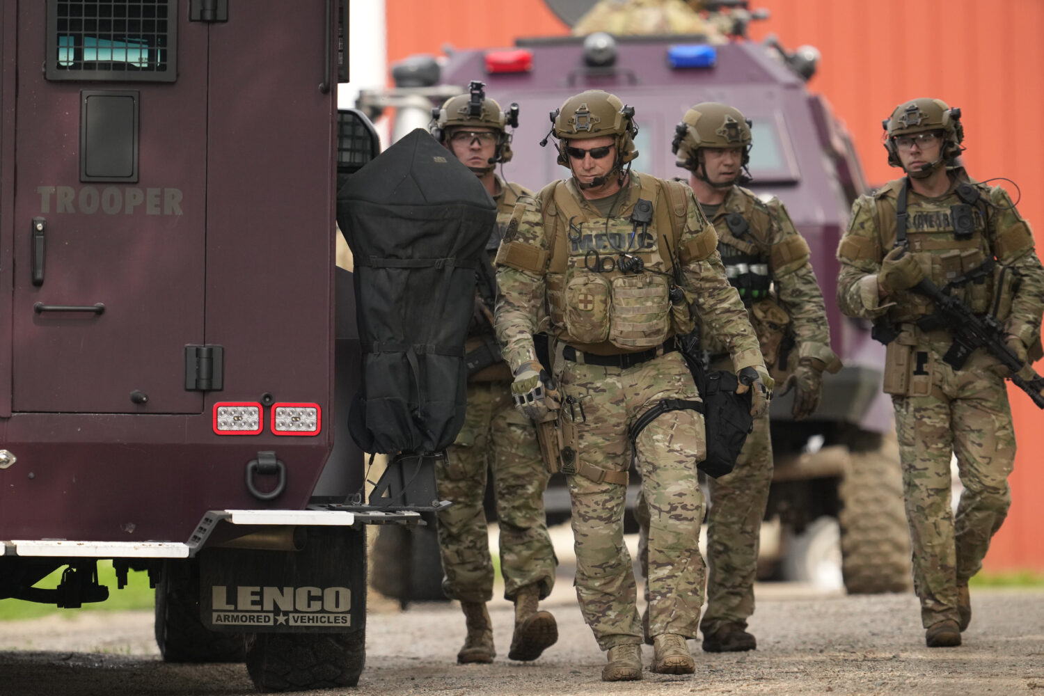 Members of law enforcement agencies search for shooting suspect, Vance Boelter, at a house Sunday, ...