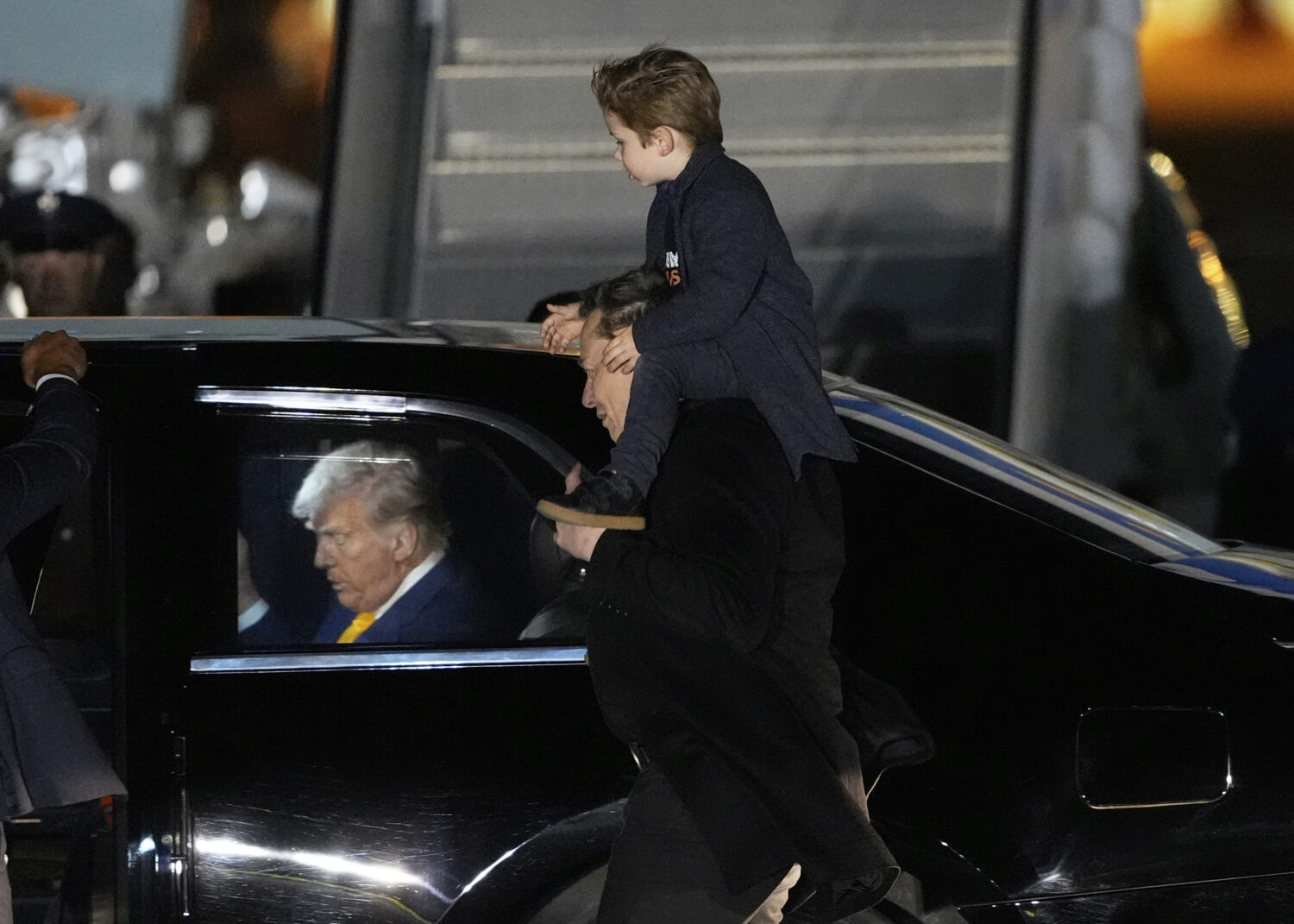 FILE - Elon Musk carries his son X Æ A-Xii as they arrives on Air Force One with President Donald ...