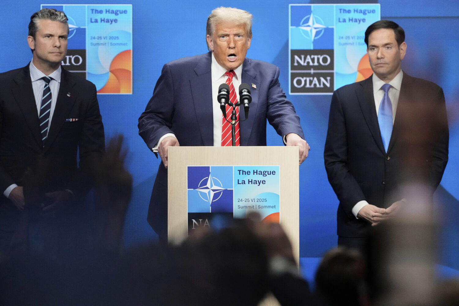 President Donald Trump speaks standing between Secretary of State Marco Rubio, right, and Defense S...