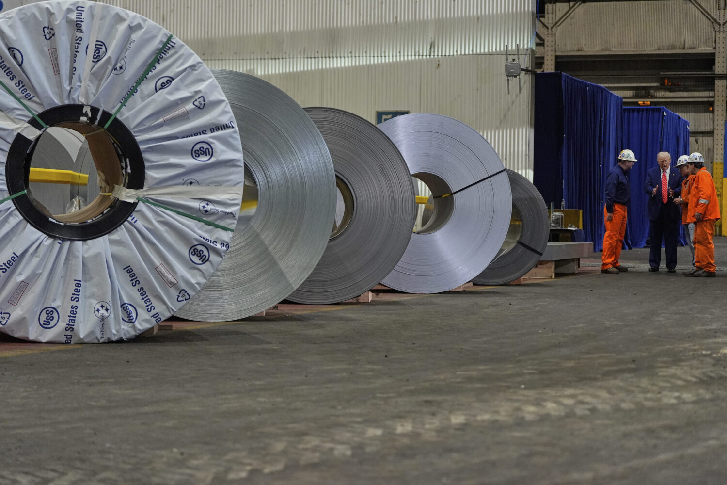 FILE - President Donald Trump talks to workers as he tours U.S. Steel Corporation's Mon Valley Work...