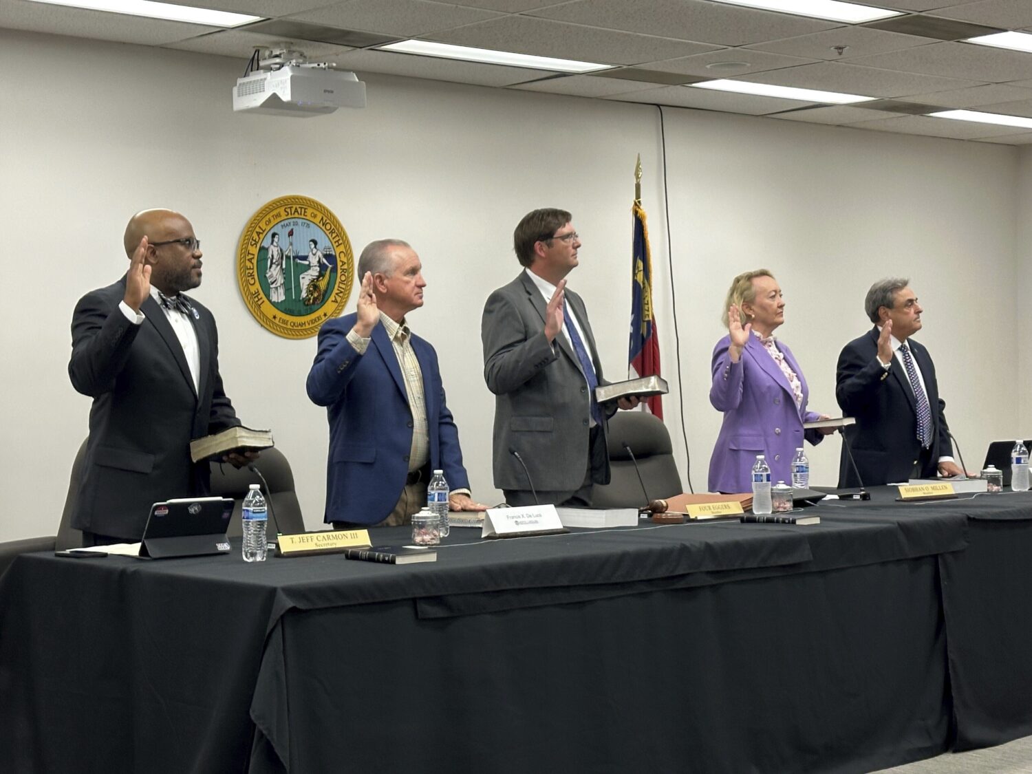 FILE - Newly appointed members of the North Carolina State Board of Elections, from left, Jeff Carm...