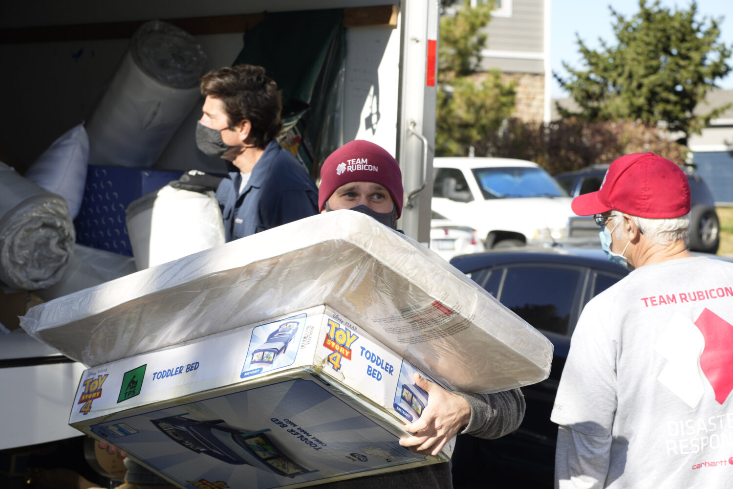 FILE - Team Rubicon volunteer Nicholas Duchnowski of Broomfield, Colo., moves belongings into an ap...