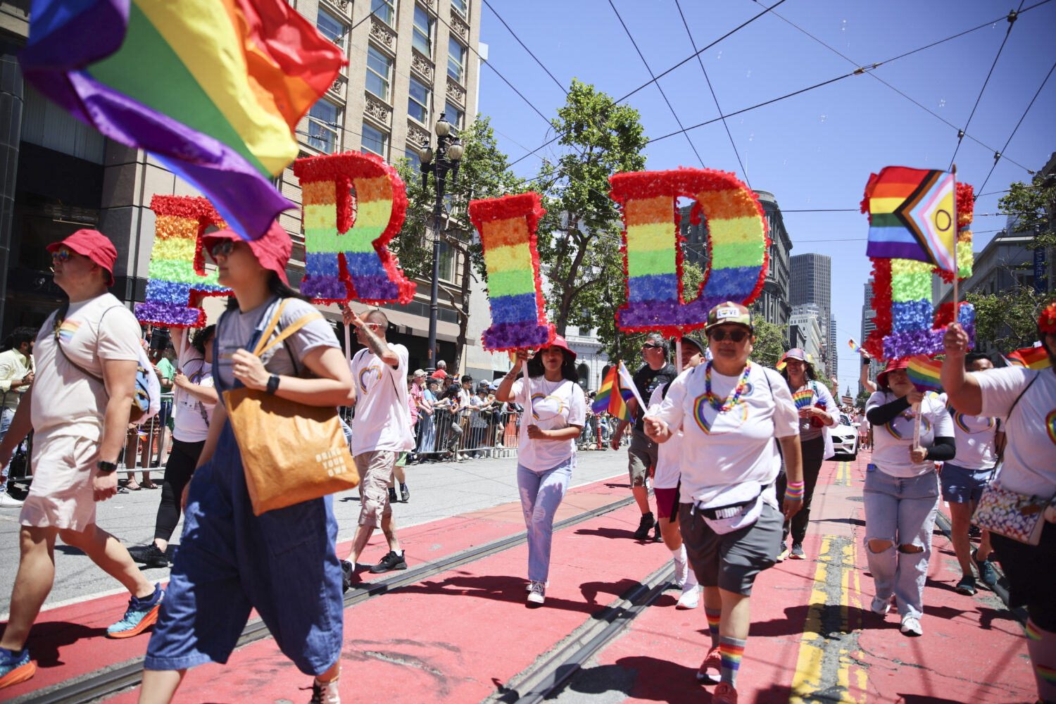 FILE - Revelers walk along Market Street during a Pride Parade, June 30, 2024, in San Francisco. (A...