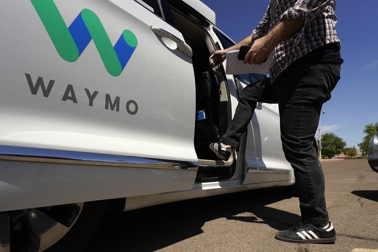 FILE - A Waymo minivan arrives to pick up passengers for an autonomous vehicle ride, April 7, 2021,...