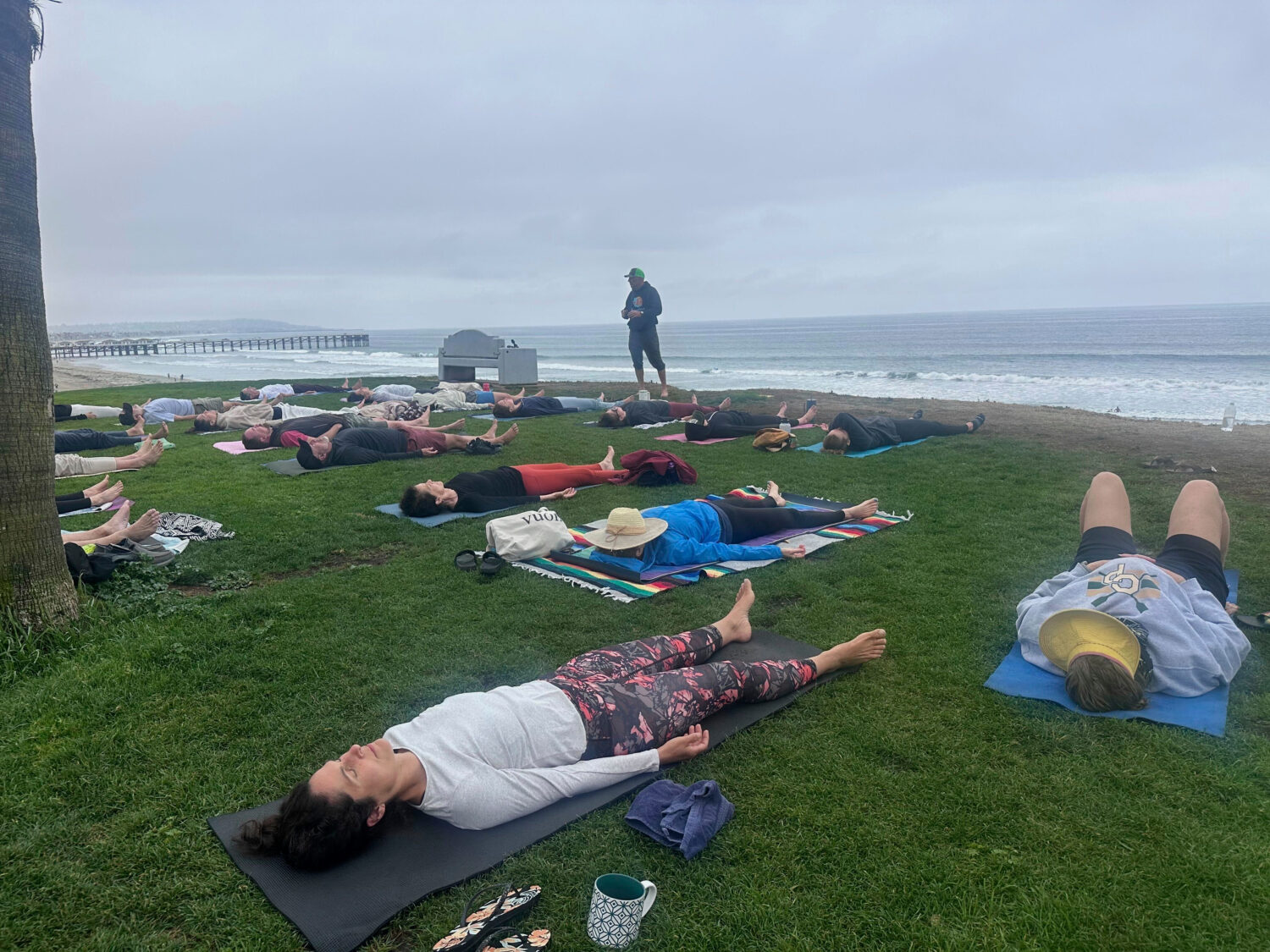 People participate in a beachfront yoga class in San Diego, California, Thursday, June 5, 2025. (AP...