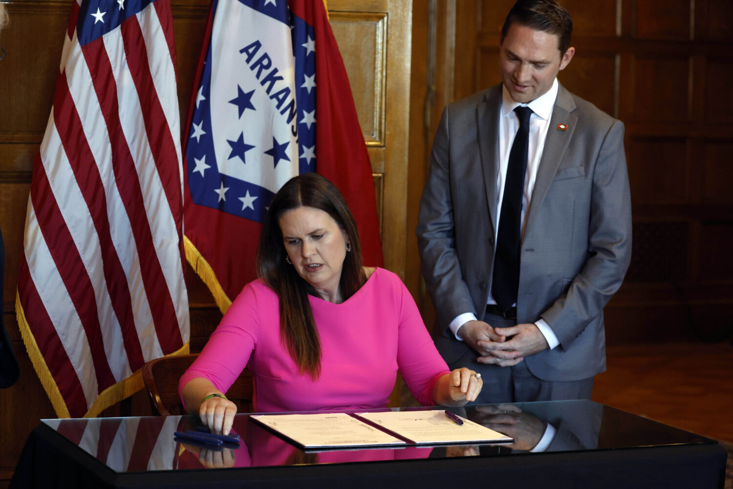 FILE - Arkansas Gov. Sarah Huckabee Sanders signs a bill requiring age verification before creating...