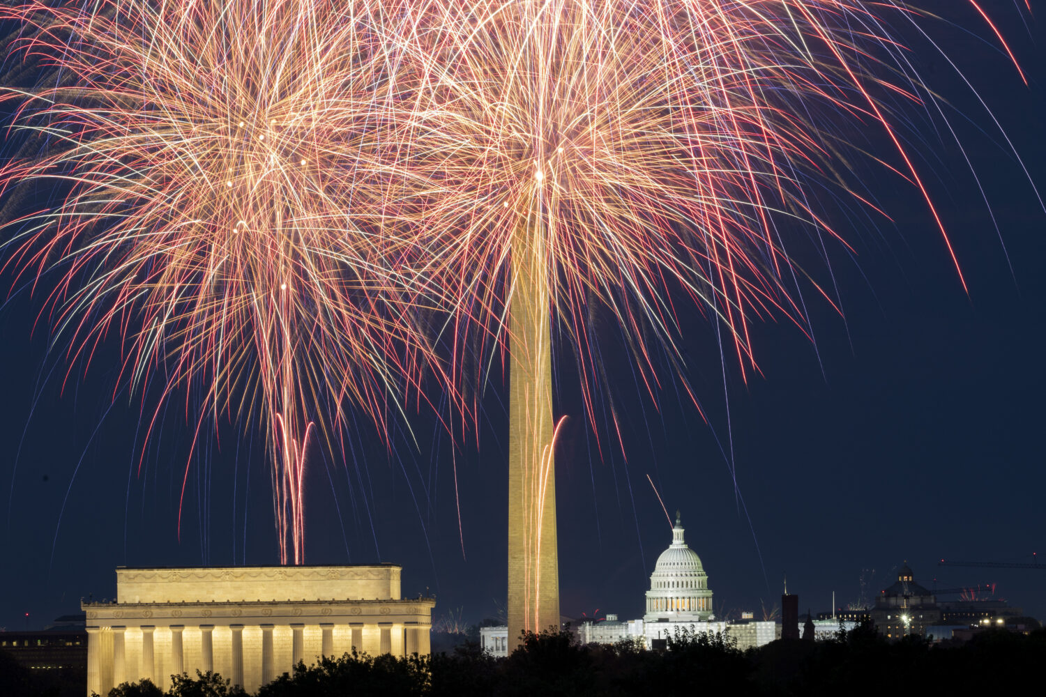 FILE - Fireworks burst above the National Mall and, from left, the Lincoln Memorial, Washington Mon...